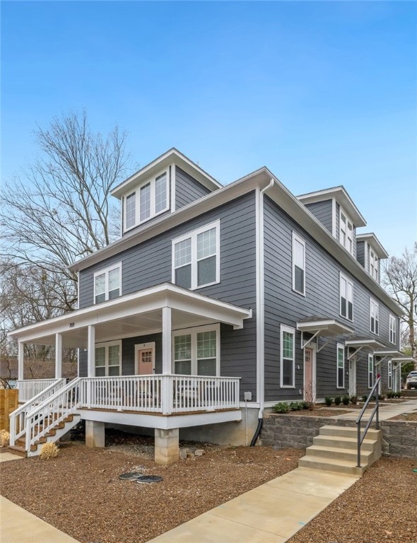 american foursquare style home with covered porch