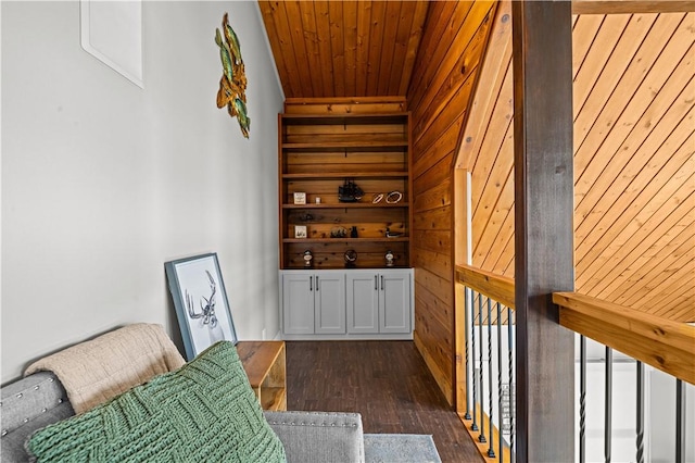 living area with wooden walls, dark hardwood / wood-style flooring, and wooden ceiling