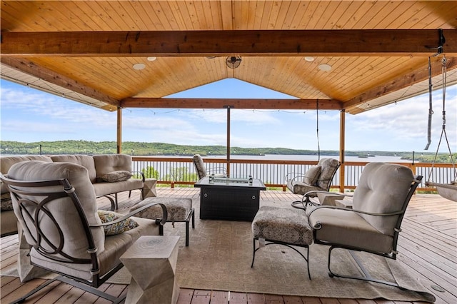 wooden deck with a gazebo, an outdoor living space with a fire pit, and a water view