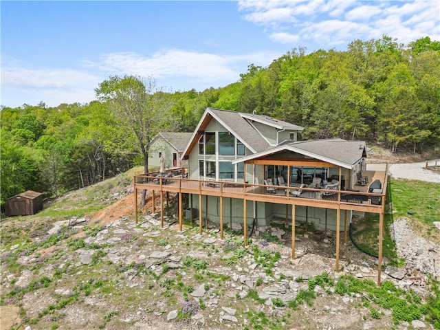 rear view of property with a wooden deck