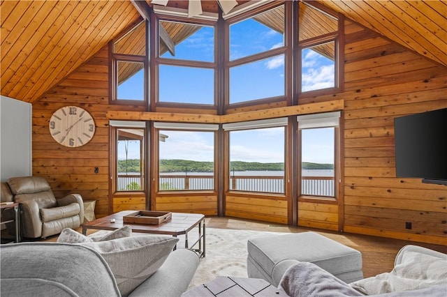 living room featuring wooden ceiling, high vaulted ceiling, light hardwood / wood-style flooring, and wood walls