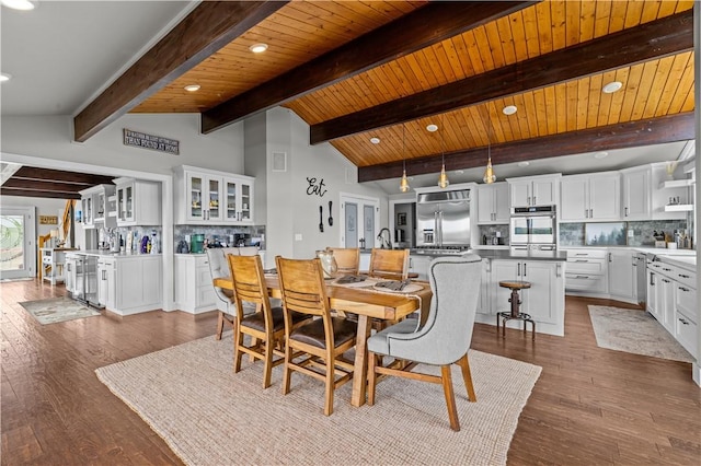 dining area featuring hardwood / wood-style flooring, wooden ceiling, and vaulted ceiling with beams