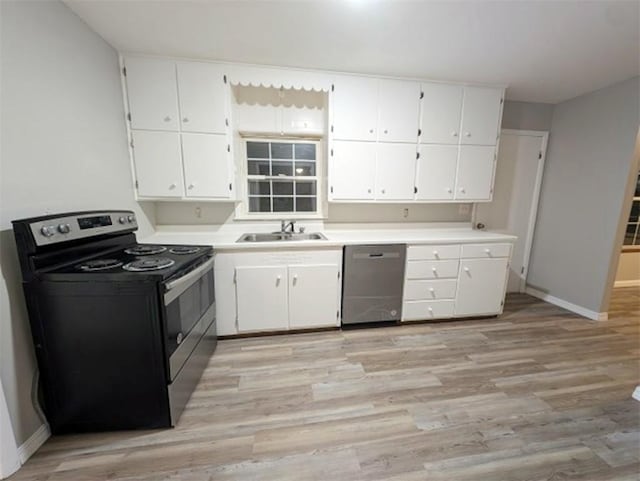 kitchen with white cabinetry, appliances with stainless steel finishes, sink, and light hardwood / wood-style flooring