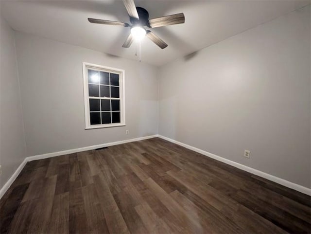 spare room with dark hardwood / wood-style floors and ceiling fan