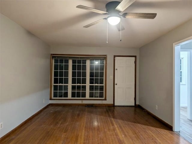 empty room featuring hardwood / wood-style floors and ceiling fan