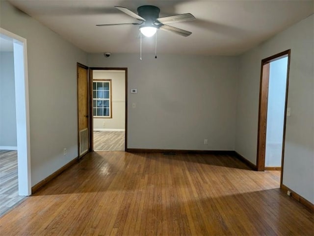 spare room featuring hardwood / wood-style flooring and ceiling fan