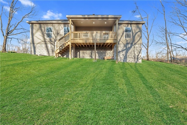 back of house featuring a yard, a wooden deck, and stairway