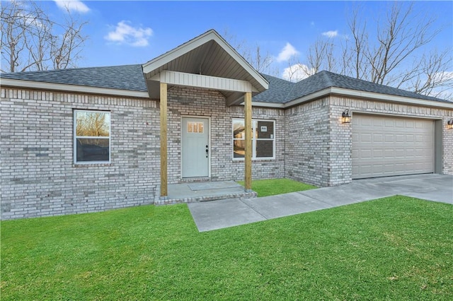 view of front facade with brick siding, a garage, concrete driveway, and a front lawn