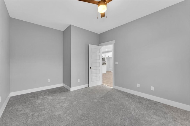 unfurnished bedroom with ceiling fan, baseboards, and carpet floors