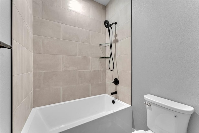 full bathroom with toilet, shower / tub combination, and a textured wall