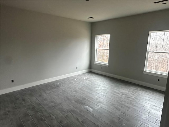 spare room featuring dark hardwood / wood-style flooring