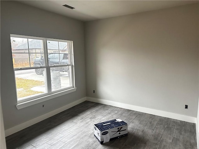 spare room with a wealth of natural light and light hardwood / wood-style floors