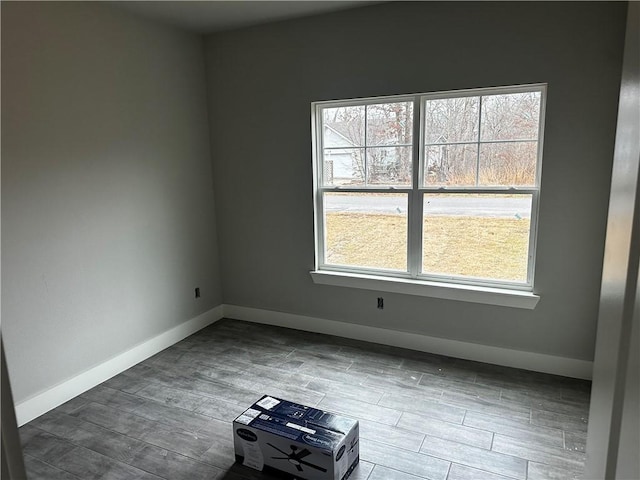 unfurnished room featuring plenty of natural light and hardwood / wood-style floors