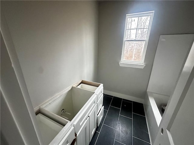 bathroom featuring vanity, a bath, and tile patterned flooring