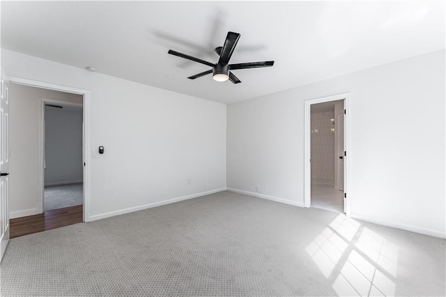 spare room featuring light colored carpet and ceiling fan