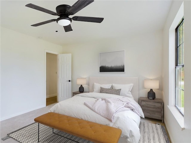 bedroom with ceiling fan and light carpet