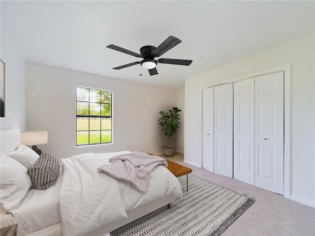 bedroom with a closet, ceiling fan, and carpet