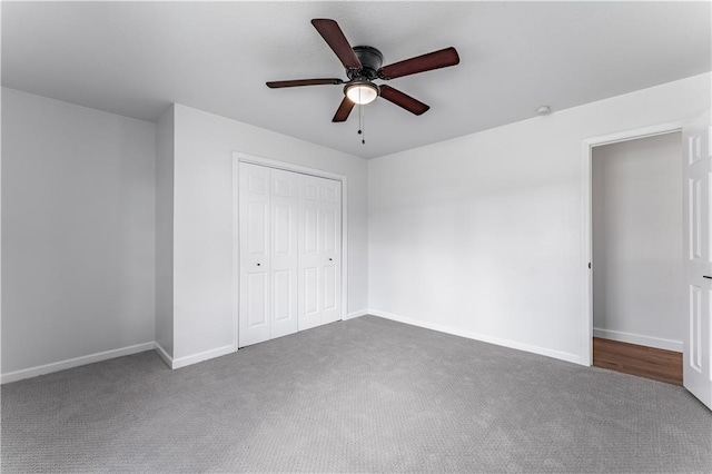 unfurnished bedroom with ceiling fan, carpet floors, and a closet