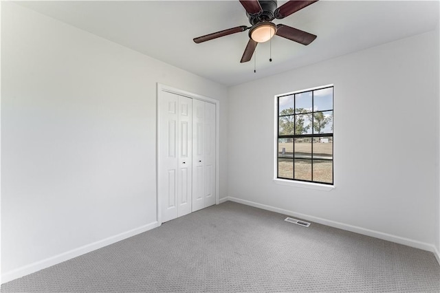 unfurnished bedroom with ceiling fan, carpet floors, and a closet