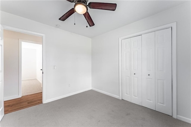 unfurnished bedroom with carpet, ceiling fan, and a closet