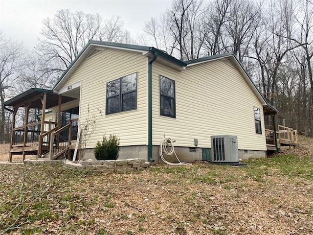 view of side of home featuring crawl space and central AC