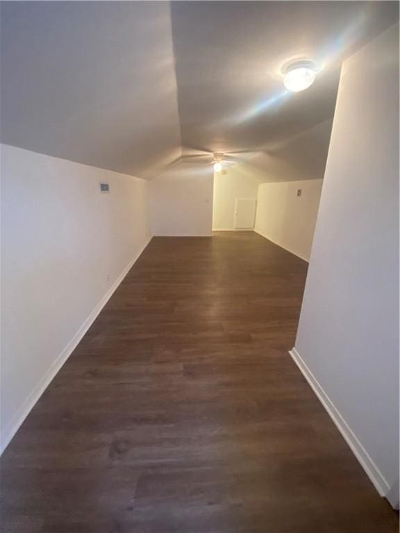 additional living space featuring lofted ceiling, dark hardwood / wood-style floors, and ceiling fan