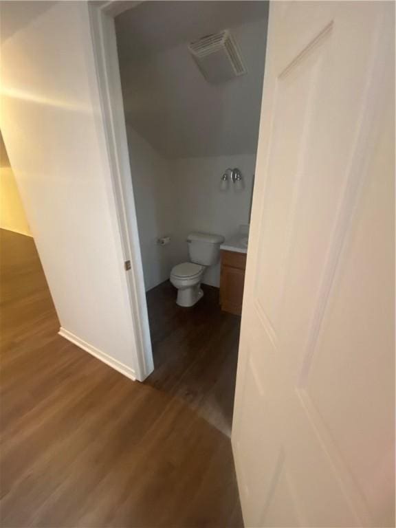 bathroom featuring hardwood / wood-style flooring, vanity, and toilet