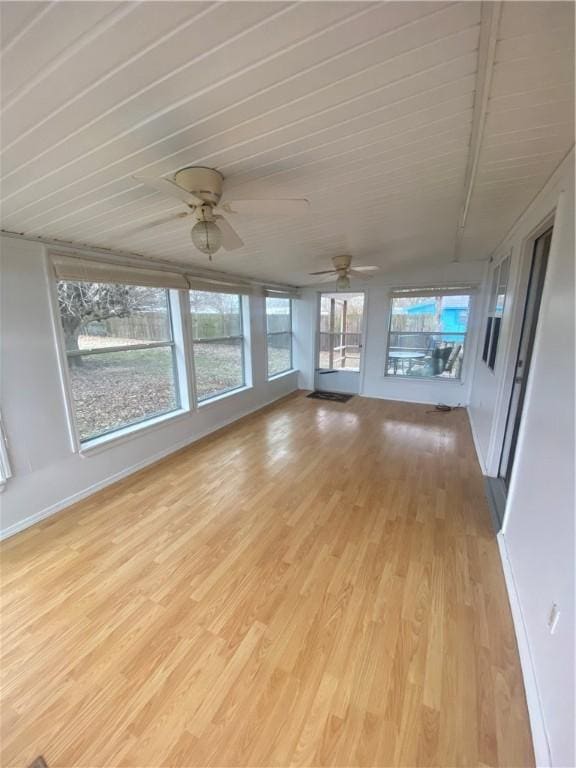 unfurnished sunroom featuring ceiling fan