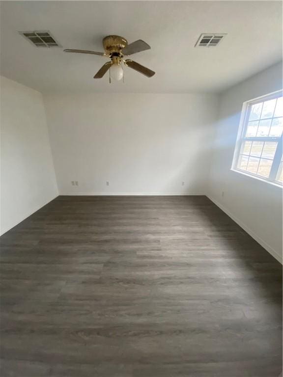 spare room with ceiling fan and dark hardwood / wood-style flooring