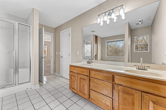 bathroom featuring tile patterned flooring, vanity, and walk in shower