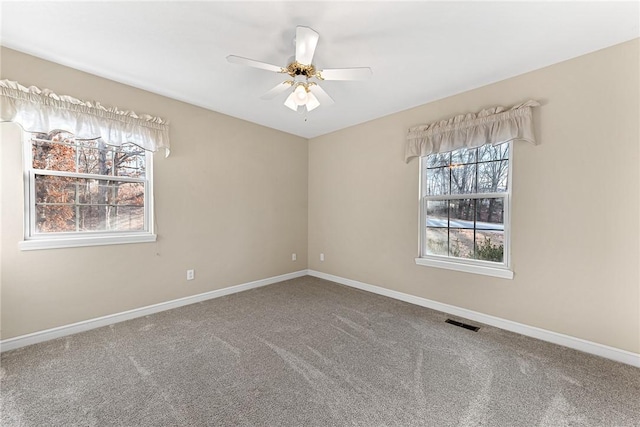 spare room with ceiling fan and carpet floors