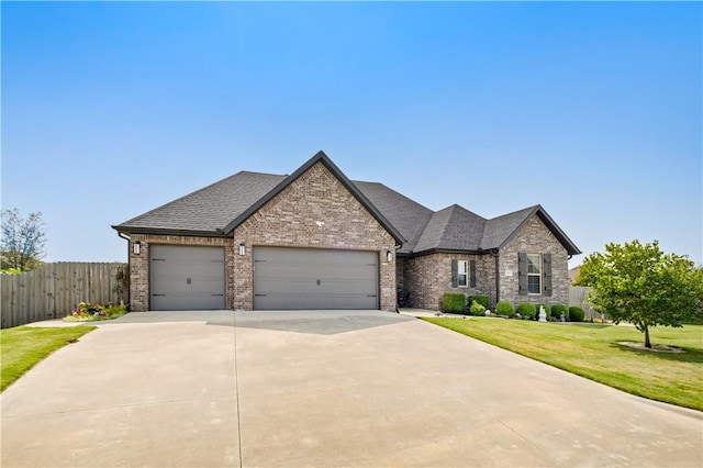 view of front of home featuring a garage and a front yard