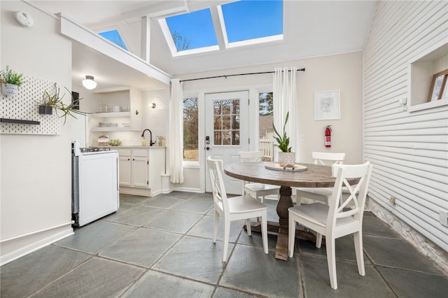 dining space with lofted ceiling and sink