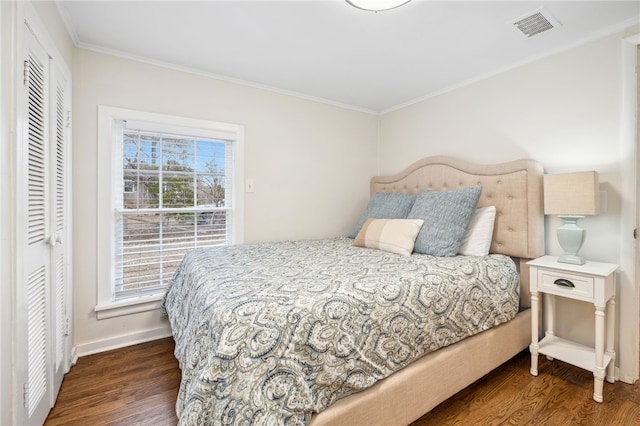 bedroom with crown molding and dark hardwood / wood-style floors