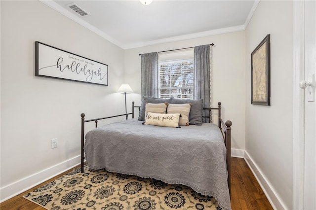 bedroom with hardwood / wood-style flooring and crown molding