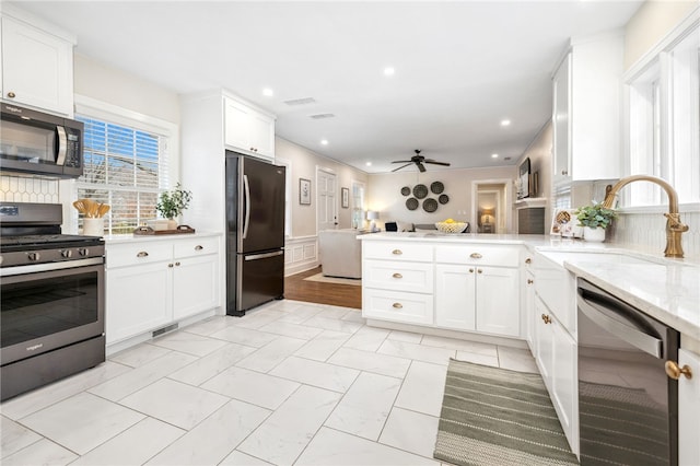 kitchen with sink, stainless steel appliances, and white cabinets