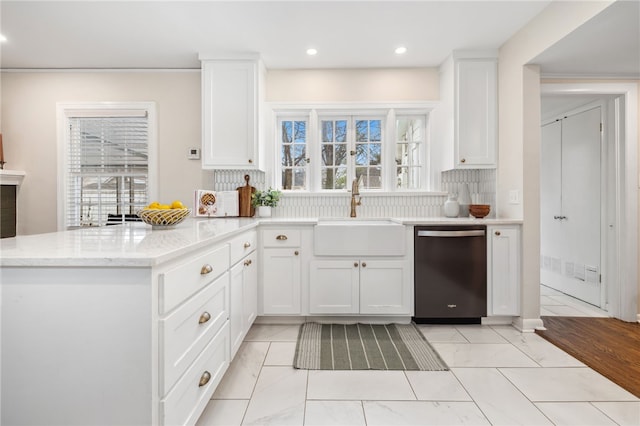 kitchen featuring tasteful backsplash, dishwasher, sink, and white cabinets