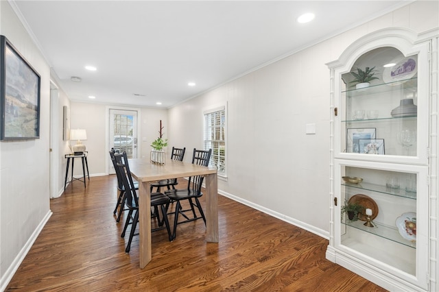 dining space featuring crown molding and dark hardwood / wood-style floors