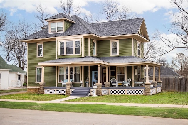 view of front of property with a porch and a front lawn