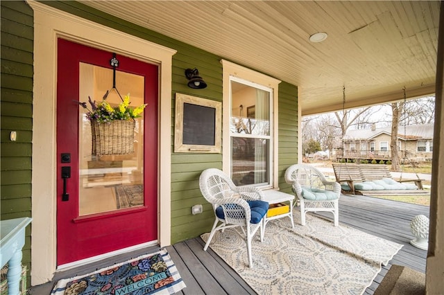 view of exterior entry with a porch