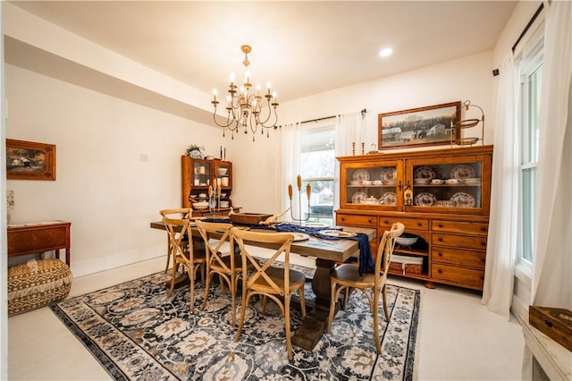 dining area featuring baseboards, recessed lighting, and an inviting chandelier