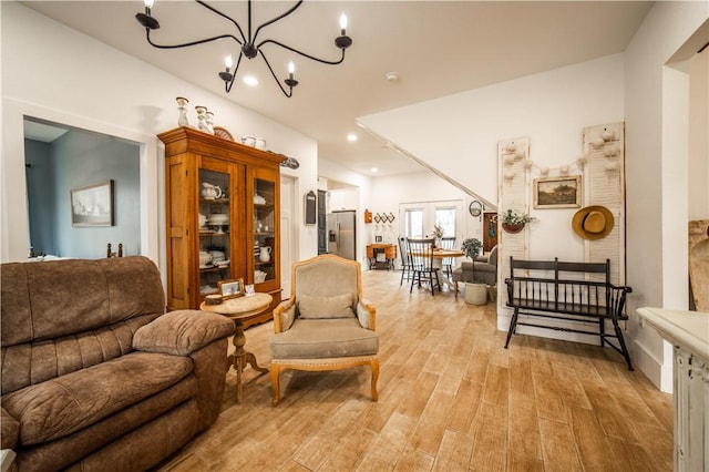 living room with a chandelier, recessed lighting, and light wood-style floors