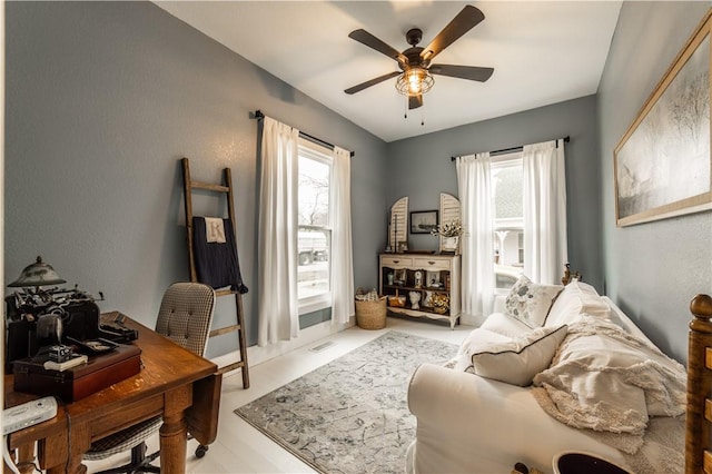 office space with a ceiling fan and visible vents