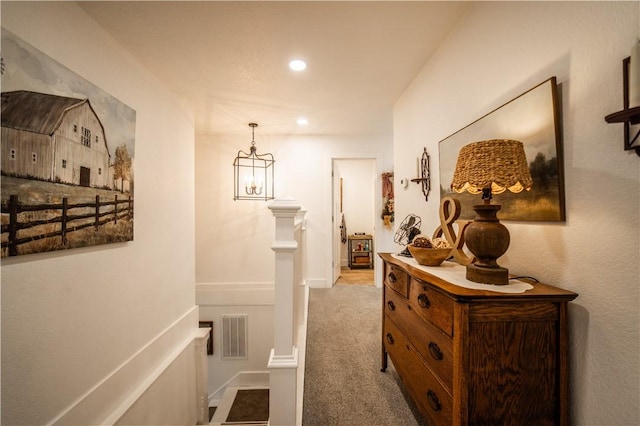 corridor with a chandelier, recessed lighting, carpet flooring, an upstairs landing, and visible vents