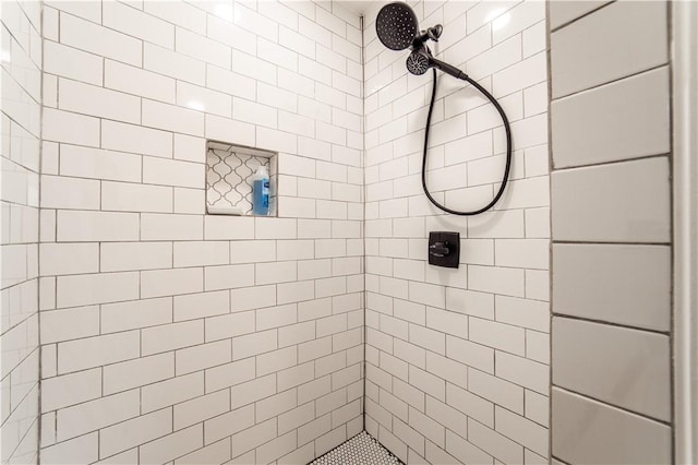 bathroom with a tile shower