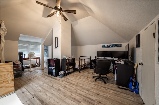 office space featuring vaulted ceiling, a ceiling fan, and wood finished floors