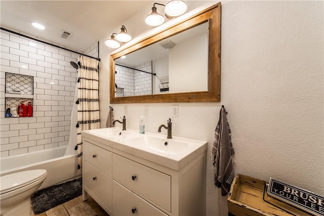 full bathroom featuring shower / bath combination with curtain, visible vents, toilet, a sink, and double vanity