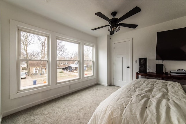 bedroom featuring light colored carpet and ceiling fan