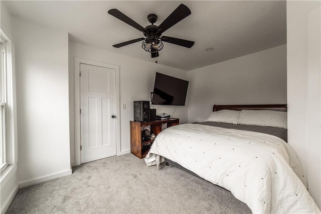 bedroom with light colored carpet and ceiling fan