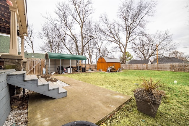 view of yard with a storage shed, a fenced backyard, a patio area, and an outdoor structure